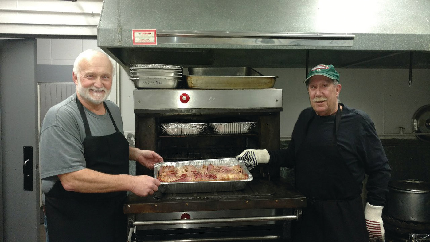 CLASSIC COOKS: Bob Hartington (left), Exalted Ruler at the Tri-city Elks, is all smiles after he and special chef Steve Lagesse checked one of the pans of corned beef they cooked for Saturday’s annual St. Patty’s Party in Warwick.